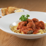 AYLA'S SPAGHETTI & MEATBALLS - Bucatini pasta, homemade Marinara sauce and juicy, tender meatballs served with cheesy garlic bread and fresh basil (contains veal pork and beef)